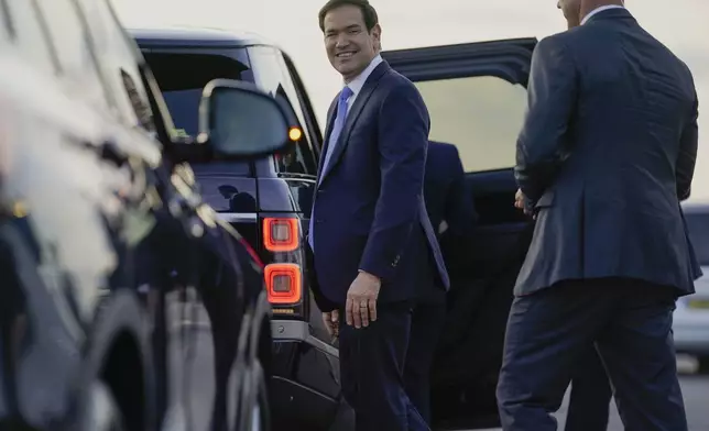 U.S. Secretary of State Marco Rubio smiles as he prepares to enter a vehicle upon arrival at London Stansted Airport, during an official visit near London, Tuesday, Sept. 16, 2025. (Nathan Howard/Pool Photo via AP)