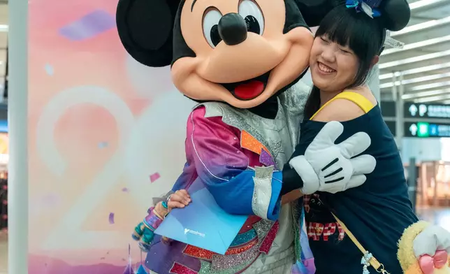 Mickey invited tourists to join the anniversary celebration.