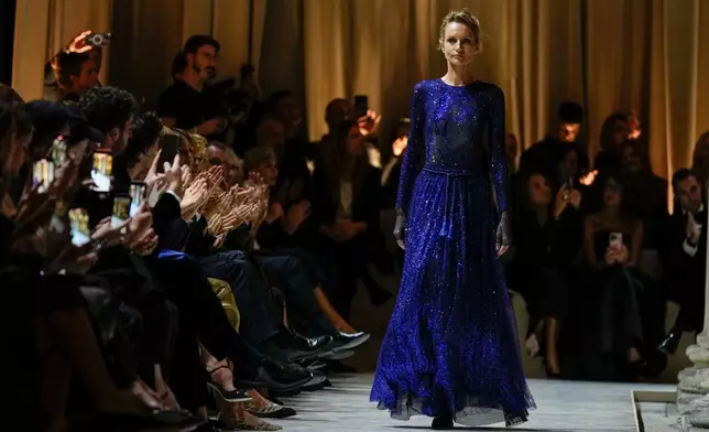 A model wears a creation as part of the Giorgio Armani Spring/Summer 2026 collection show in Milan, Italy, Sunday, Sept. 28, 2025. (AP Photo/Luca Bruno)