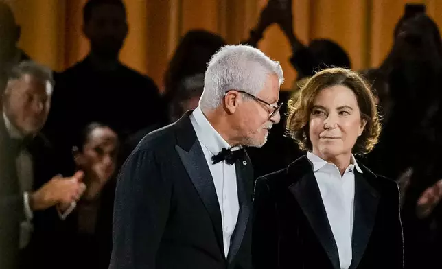 Leo Dell'Orco, left, and Silvana Armani acknowledge the applause at the end of the Giorgio Armani Spring/Summer 2026 collection show in Milan, Italy, Sunday, Sept. 28, 2025. (AP Photo/Luca Bruno)