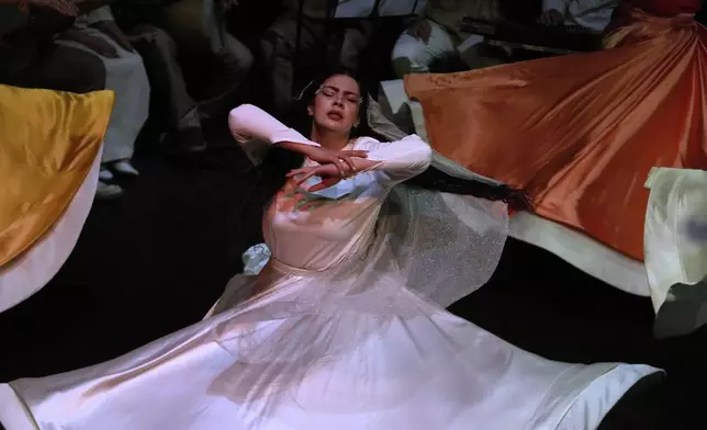 Iranian actress Jeyran Barikani dances during a musical play "Mehrara", a love story which takes place in Qajar dynasty era, directed by Daniyal Ghafari, at Neauphle-le-Château theater hall, in Tehran, Iran, Tuesday, Sept. 2, 2025. (AP Photo/Vahid Salemi)