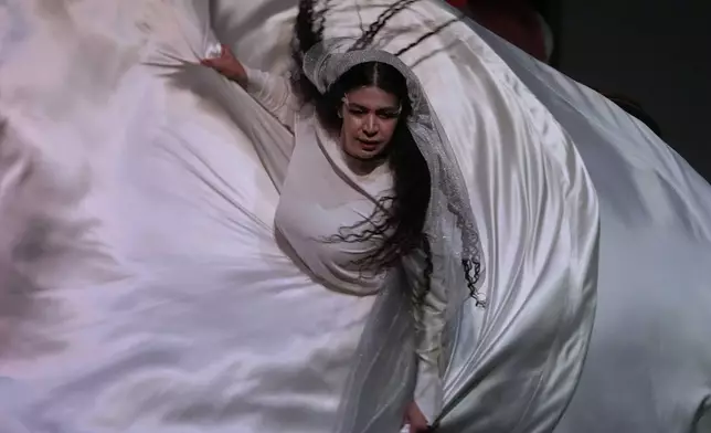 Iranian actress Jeyran Barikani dances during a musical play "Mehrara", a love story which takes place in Qajar dynasty era, directed by Daniyal Ghafari, at Neauphle-le-Château theater hall, in Tehran, Iran, Tuesday, Sept. 2, 2025. (AP Photo/Vahid Salemi)