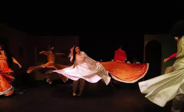 Iranian actress Jeyran Barikani, center, and others dance during a musical play "Mehrara", a love story which takes place in Qajar dynasty era, directed by Daniyal Ghafari, at Neauphle-le-Château theater hall, in Tehran, Iran, Wednesday, Sept. 3, 2025. (AP Photo/Vahid Salemi)
