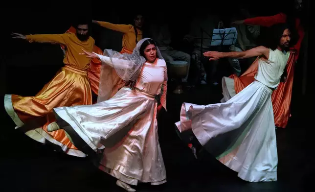 Iranian actors Jeyran Barikani, center, Kamal Razavi, right, and others dance during a musical play "Mehrara", a love story which takes place in Qajar dynasty era, directed by Daniyal Ghafari, at Neauphle-le-Château theater hall, in Tehran, Iran, Tuesday, Sept. 2, 2025. (AP Photo/Vahid Salemi)
