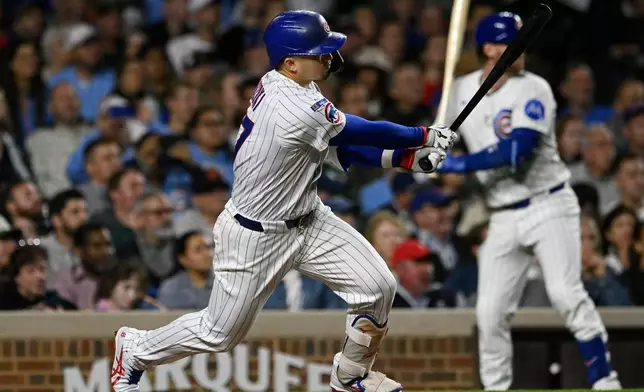 Chicago Cubs' Seiya Suzuki watches his RBI double during the third inning of a baseball game against the New York Mets, Wednesday, Sept. 24, 2025, in Chicago. (AP Photo/Paul Beaty)
