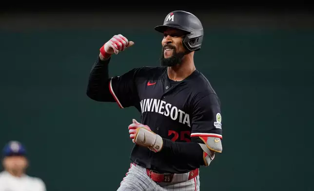 Minnesota Twins' Byron Buxton celebrate after hitting a solo home run in the first inning of a baseball game against the Texas Rangers Wednesday, Sept. 24, 2025, in Arlington, Texas. (AP Photo/Tony Gutierrez)