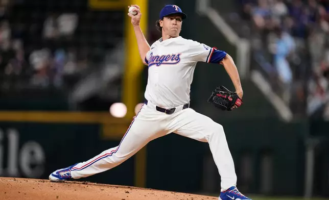 Texas Rangers' Jacob deGrom throws to the Minnesota Twins in the first inning of a baseball game Wednesday, Sept. 24, 2025, in Arlington, Texas. (AP Photo/Tony Gutierrez)