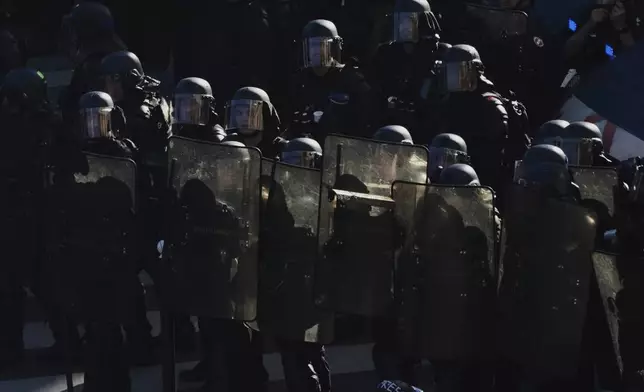 Police officers stand guard during a demonstration called by major trade unions to oppose budget cuts, in Paris, France, Thursday, Sept. 18, 2025. (AP Photo/Aurelien Morissard)