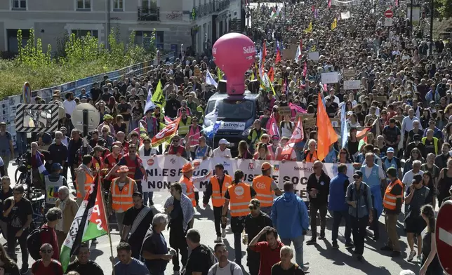 Demonstrators march during a protest called by major trade unions to oppose budget cuts, in Nantes, western France, Thursday, Sept. 18, 2025. (AP Photo/Mathieu Pattier)