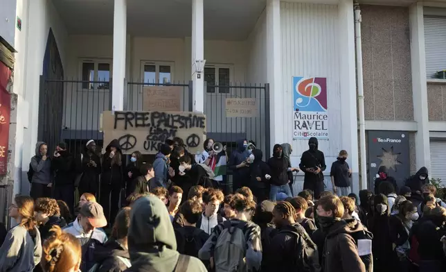Students block the entrance of a school during a protest called by major trade unions to oppose budget cuts, in Paris, France, Thursday, Sept. 18, 2025. (AP Photo/Michel Euler)
