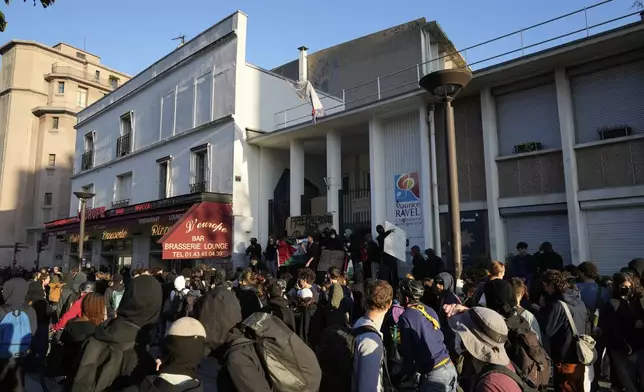 Students block the entrance of a school during a protest called by major trade unions to oppose budget cuts, in Paris, France, Thursday, Sept. 18, 2025. (AP Photo/Michel Euler)