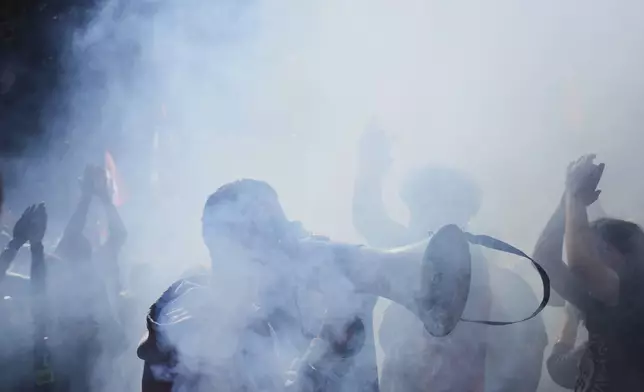 Protesters march during a demonstration called by major trade unions to oppose budget cuts, in Paris, France, Thursday, Sept. 18, 2025. (AP Photo/Aurelien Morissard)