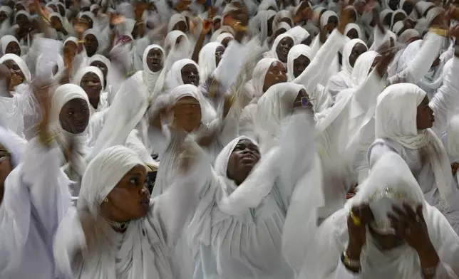 CORRECTS DATE Women sing and gesture as they mark Prophet Muhammad's birthday, known as Mawlid, in Dakar, Senegal, Friday, Sept. 5, 2025. (AP Photo/Misper Apawu)