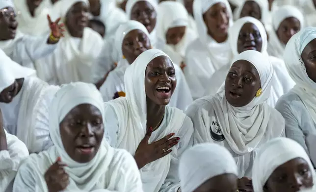 A woman recites prayers as people mark Prophet Muhammad's birthday, known as Mawlid, in Dakar, Senegal, Friday, Sept. 5, 2025. (AP Photo/Misper Apawu)