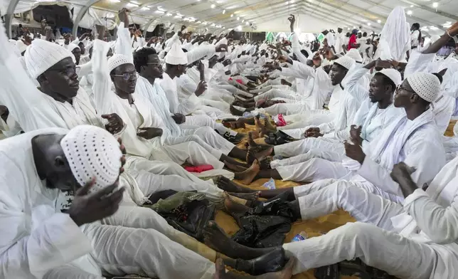 Men sing and gesture as they mark Prophet Muhammad's birthday, known as Mawlid, in Dakar, Senegal, Friday, Sept. 5, 2025. (AP Photo/Misper Apawu)