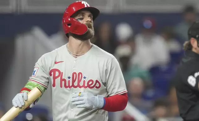 Philadelphia Phillies' J.T. Realmuto reacts after striking out during the third inning of a baseball game against the Miami MarlinsSaturday, Sept. 6, 2025, in Miami. (AP Photo/Marta Lavandier)
