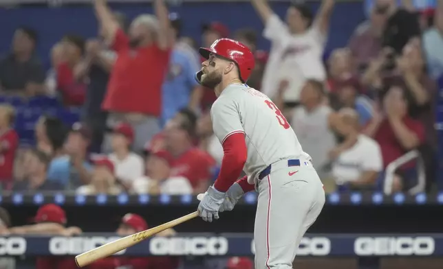 Philadelphia Phillies' Bryce Harper (3) hits a home run during the first inning of a baseball game against the Miami Marlins Saturday, Sept. 6, 2025, in Miami. (AP Photo/Marta Lavandier)
