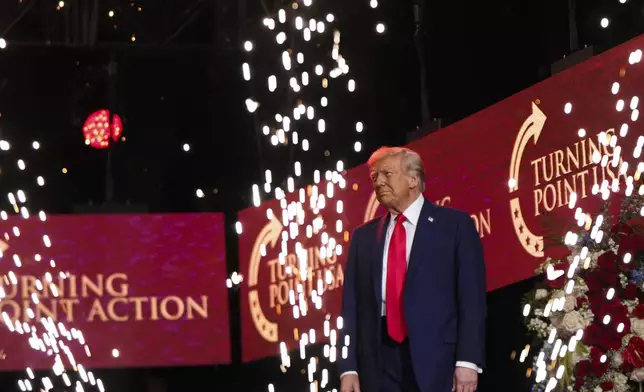 President Donald Trump walks on stage to speak at a memorial for conservative activist Charlie Kirk, Sunday, Sept. 21, 2025, at State Farm Stadium in Glendale, Ariz. (AP Photo/Julia Demaree Nikhinson)