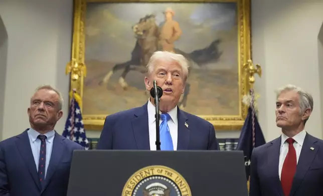 President Donald Trump speaks in the Roosevelt Room of the White House, Monday, Sept. 22, 2025, in Washington, as Health and Human Services Secretary Robert F. Kennedy Jr., left, and Centers for Medicare &amp; Medicaid Services administrator Dr. Mehmet Oz listen. (AP Photo/Mark Schiefelbein)