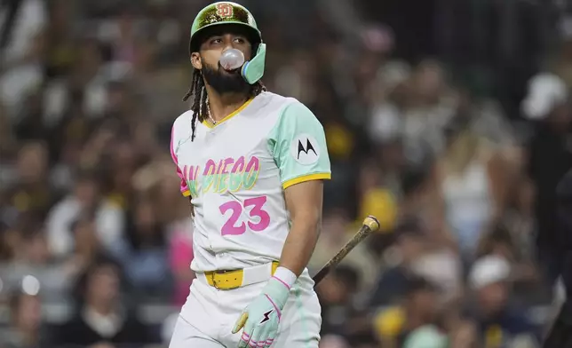 San Diego Padres' Fernando Tatis Jr. blows a bubble after striking out to end the eighth inning of a baseball game against the Colorado Rockies Friday, Sept. 12, 2025, in San Diego. (AP Photo/Gregory Bull)