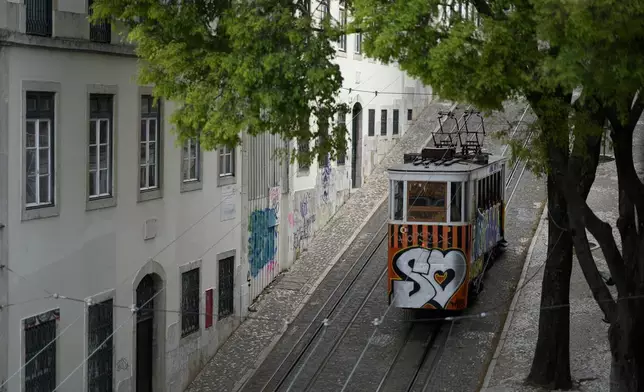 FILE - The Gloria funicular makes its way uphill in Lisbon, on April 12, 2023. (AP Photo/Armando Franca, File)