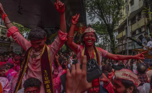 Devotees dance as an idol of the elephant-headed Hindu god Ganesha is taken for immersion on the final day of the ten-day-long Ganesh Chaturthi festival in Mumbai, India, Saturday, Sept. 6, 2025. (AP Photo/Rafiq Maqbool)