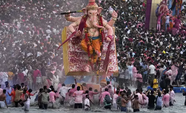An idol of elephant-headed Hindu god Ganesha is immersed at Arabian Sea on the final day of the ten-day long Ganesh Chaturthi festival in Mumbai, India, Saturday, Sept. 6, 2025. (AP Photo/Rajanish Kakade)