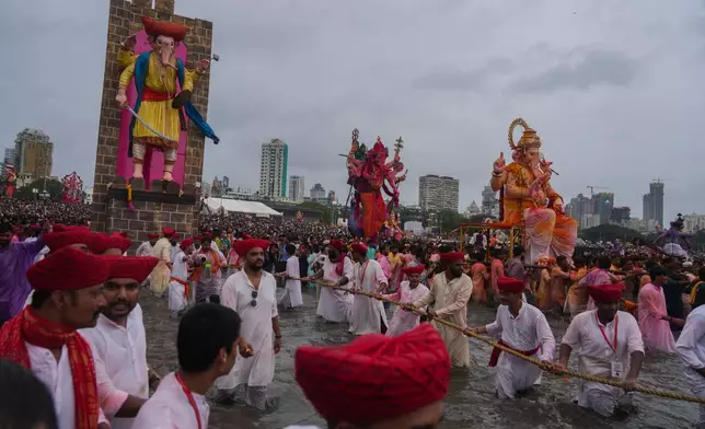 Devotees prepare to immerse a giant idols of elephant-headed Hindu god Ganesha in the Arabian Sea, marking the end of the 10-day long Ganesh Chaturthi festival in Mumbai , India, Saturday, Sept. 6, 2025. (AP Photo/Rafiq Maqbool)