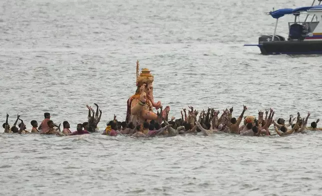 An idol of elephant-headed Hindu god Ganesha is immersed at Arabian Sea on the final day of the ten-day long Ganesh Chaturthi festival in Mumbai, India, Saturday, Sept. 6, 2025. (AP Photo/Rajanish Kakade)