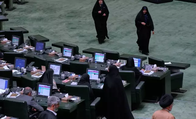 Iranian lawmakers attend an open session of parliament in Tehran, Iran, Sunday, Sept. 28, 2025. (AP Photo/Vahid Salemi)