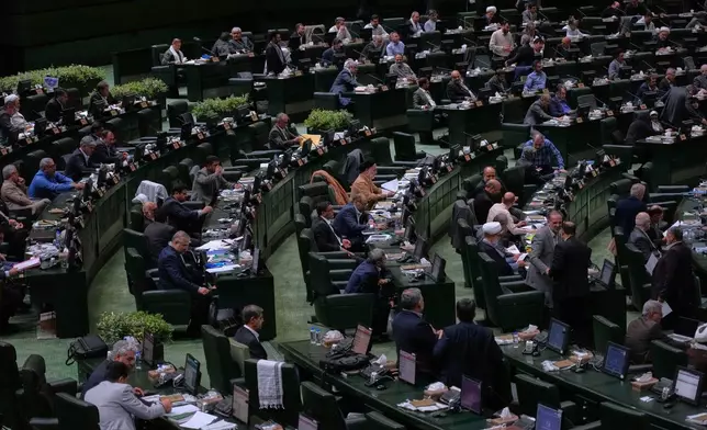 Iranian lawmakers attend an open session of parliament in Tehran, Iran, Sunday, Sept. 28, 2025. (AP Photo/Vahid Salemi)