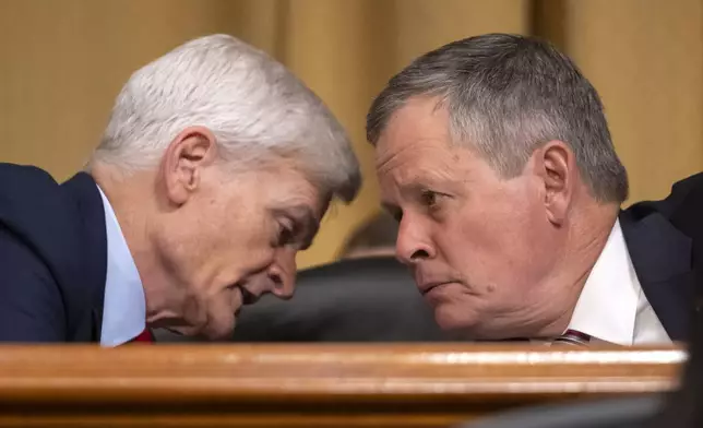 Sen. Bill Cassidy, R-La., left, talks with Sen. Steve Daines, R-Mont., as Secretary of Health and Human Services Robert F. Kennedy Jr., appears before the Senate Finance Committee, on Capitol Hill in Washington, Thursday, Sept. 4, 2025. (AP Photo/Mark Schiefelbein)