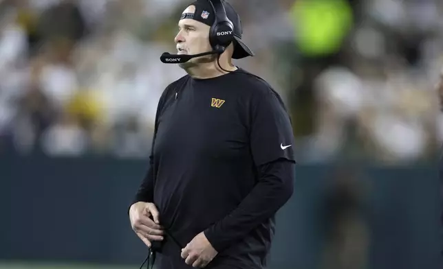 Washington Commanders head coach Dan Quinn watches from the sidelines during the second half of an NFL football game against the Green Bay Packers Thursday, Sept. 11, 2025, in Green Bay, Wis. (AP Photo/Matt Ludtke)