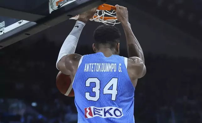 Greece's Giannis Antetokounmpo dunks the ball during the Eurobasket, European Basketball Championship Group C match between Spain and Greece at Spyros Kyprianou Arena, in Limassol, Cyprus, Thursday, Sept. 4, 2025. (AP Photo/Sakis Savvides)
