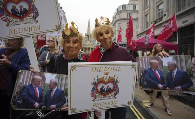 Protesters wear royal costumes during a demonstration of the Stop Trump Coalition group against President Donald Trump's state visit in London, Wednesday, Sept. 17, 2025.(AP Photo/Kin Cheung)