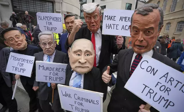 Protesters wear masks of politicians during a demonstration of the Stop Trump Coalition group against President Donald Trump's state visit in London, Wednesday, Sept. 17, 2025. (AP Photo/Kin Cheung)