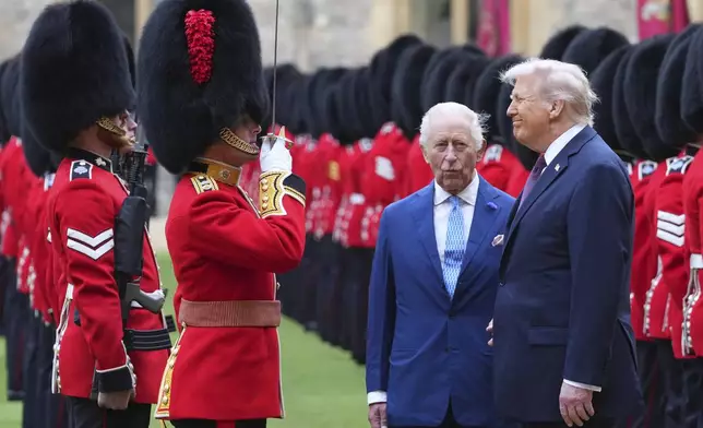 President Donald Trump and Britain's King Charles III review the Guard of Honour after the arrival at Windsor Castle in Windsor, England, Wednesday, Sept. 17, 2025.(AP Photo/Kirsty Wigglesworth, Pool)