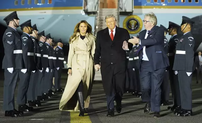 President Donald Trump and first lady Melania Trump are greeted by The Viscount Hood, Lord-in-Waiting, center-right, as they arrive at Stansted Airport near London, Tuesday, Sept. 16, 2025. (AP Photo/Evan Vucci)