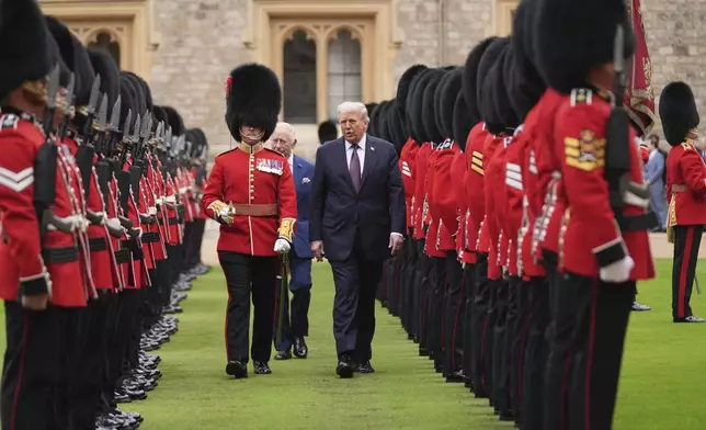 President Donald Trump and Britain's King Charles III inspect the guard of honor during an arrival ceremony at Windsor Castle, in Windsor, England, Wednesday, Sept. 17, 2025. (AP Photo/Evan Vucci)