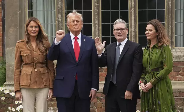 President Donald Trump and Britain's Prime Minister Keir Starmer gesture next to first lady Melania Trump and Victoria Starmer after watching a display by the British Parachute Regiment's "Red Devils" display team at Chequers near Aylesbury, England, Thursday, Sept. 18, 2025. (AP Photo/Evan Vucci)