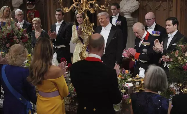 U.S. President Donald Trump, alongside Britain's King Charles, Kate, Princess of Wales, U.S. Secretary of State Marco Rubio and guests attend the State Banquet in Windsor Castle, England, on day one of U.S. President Donald Trump and First Lady Melania Trump's second state visit to the UK, Wednesday Sept. 17, 2025. (Yui Mok/PA via AP, Pool Photo via AP)