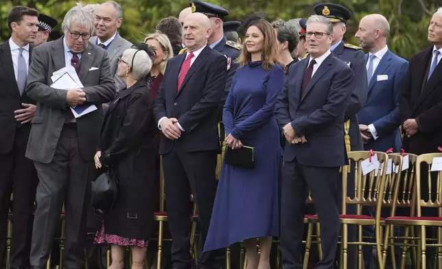 From front right, Britain's Prime Minister Keir Starmer, his wife Victoria Starmer and Britain's Defense Secretary John Healey take their places to watch a Beating Retreat musical performance on the East Lawn of Windsor Castle, in Windsor, England, Wednesday, Sept. 17, 2025. (AP Photo/Evan Vucci)
