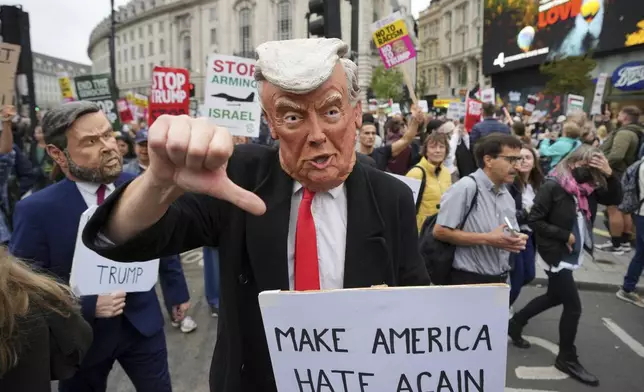 A protester wears a Trump mask during a demonstration of the Stop Trump Coalition group against President Donald Trump's state visit in London, Wednesday, Sept. 17, 2025.(AP Photo/Kin Cheung)