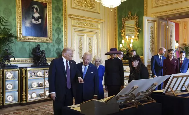 President Donald Trump, first lady Melania Trump, Britain's King Charles III and Britain's Queen Camilla view a special display of items from the Royal Collection relating to the United States of America, in the Green Drawing Room at Windsor Castle, in Windsor, England, Wednesday, Sept. 17, 2025. (AP Photo/Evan Vucci)