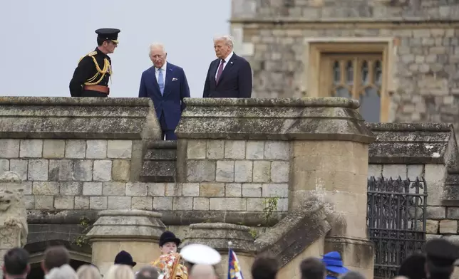 President Donald Trump and Britain's King Charles III walk together as they arrive for a Beating Retreat musical performance on the East Lawn of Windsor Castle, in Windsor, England, Wednesday, Sept. 17, 2025. (AP Photo/Evan Vucci)