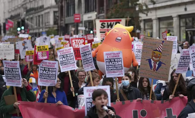 Protesters join a demonstration of the Stop Trump Coalition group against President Donald Trump's state visit in London, Wednesday, Sept. 17, 2025.(AP Photo/Joanna Chan)