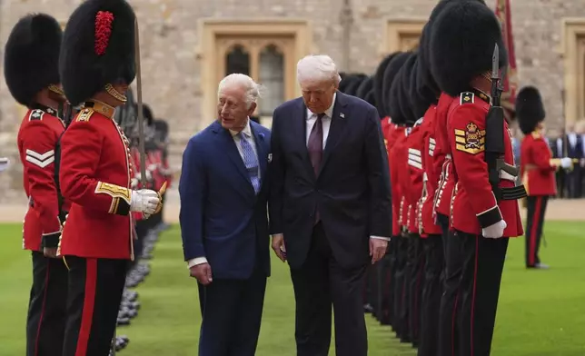President Donald Trump and Britain's King Charles III inspect the guard of honor during an arrival ceremony at Windsor Castle, in Windsor, England, Wednesday, Sept. 17, 2025. (AP Photo/Evan Vucci)