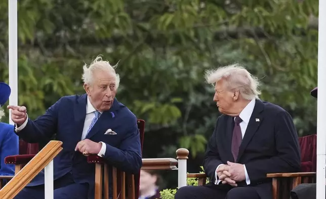President Donald Trump, right, speaks with Britain's King Charles III as they attend a Beating Retreat musical performance on the East Lawn of Windsor Castle, in Windsor, England, Wednesday, Sept. 17, 2025. (AP Photo/Evan Vucci)