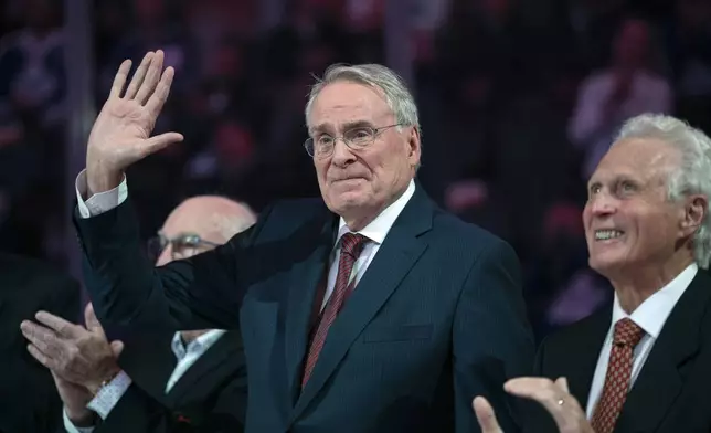 Ken Dryden, center, is recognized during a pregame ceremony to commemorate the 50th anniversary of Team Canada's victory in the 1972 Summit Series, prior to a preseason NHL hockey game between the Montreal Canadiens and the Toronto Maple Leafs in Toronto, Sept. 28, 2022. (Nick Iwanyshyn/The Canadian Press via AP)