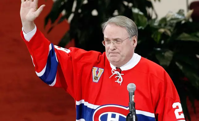 FILE - Former Montreal Canadiens goaltender Ken Dryden waves to the crowd at the Bell Centre as his number is retired during a pre-game ceremony, on Jan. 29, 2007 in Montreal. (Ryan Remiorz/The Canadian Press via AP, File)